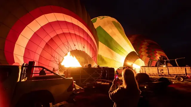 Hot air balloons being inflated before a sunrise flight in Cappadocia