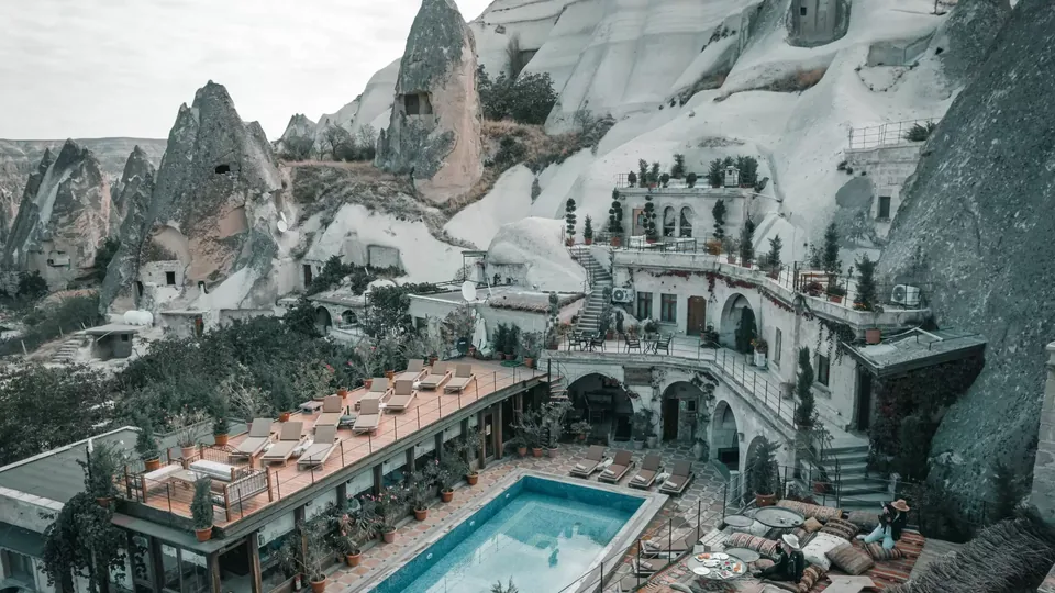 Cave hotel pool and rock-cut terraces in Goreme, Cappadocia